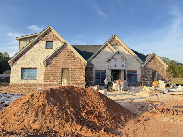 Cut stone and brick going up across the front gables